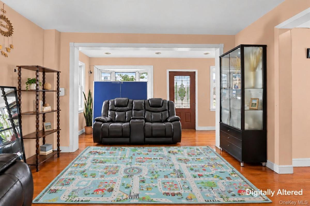 Hardwood-finish flooring, recessed lighting, and a front entry door with leaded glass accents