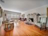 Front to back living room with stone wood burning fireplace