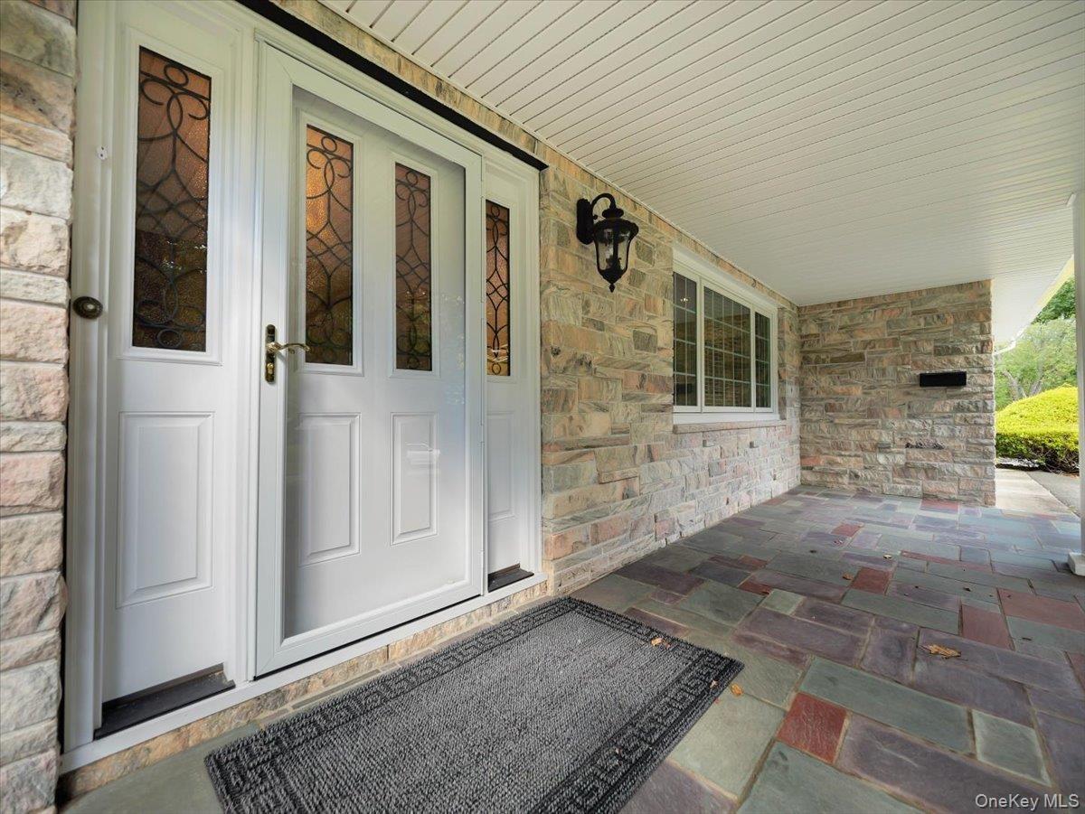 Covered front entry with multi-color natural Vermont Slate tile.