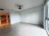 Large-format tile flooring, ceiling fan, and floor-to-ceiling windows