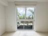 Large rectangular window featuring dual-pane glass, a valance, and a retractable roller shade, complemented by tile flooring and neutral wall finishes