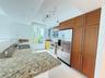 Kitchen featuring wood cabinetry, stone countertops, stainless steel appliances, a double-basin sink, and track lighting