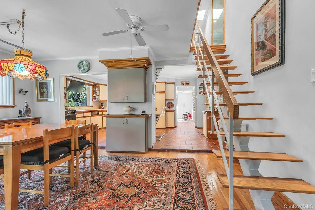 Open-tread staircase with wood risers and metal railing