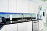 Kitchen featuring flat-panel white cabinetry, black stone countertops, an undermount stainless steel sink, a stainless steel dishwasher, and a glass t