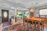 Wood-finish flooring throughout, featuring a dark wood entry door with an oval decorative glass insert