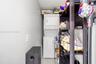 Stacked white laundry unit featuring integrated dryer and washing machine