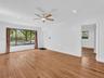 Living room view featuring wood-finish flooring, crown molding, recessed lighting, and a ceiling fan. House for rent in Coral Gables. House for rent l