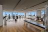 Fitness center featuring wood-finish flooring, floor-to-ceiling windows, and recessed lighting