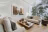 Double-height ceiling, full-height floor-to-ceiling windows, and wood-finish flooring