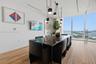 Floor-to-ceiling windows, wood-finish flooring, multi-pendant modern lighting, and recessed ceiling track lighting
