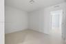Neutral-toned large-format tile flooring and minimalist crisp white walls