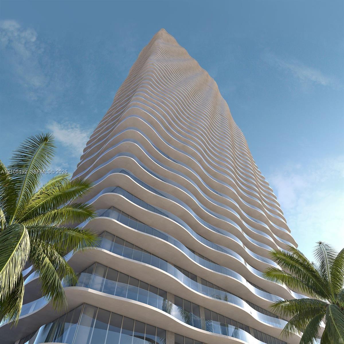 High-rise tower featuring a serpentine architectural design, undulating structural balconies, floor-to-ceiling glass windows, and glass-paneled balcon