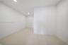 Neutral interior space featuring large-format tile flooring, smooth wall finishes, and recessed ceiling lighting
