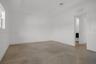 Neutral-toned tile flooring, recessed ceiling detailing, and crisp white wall finishes