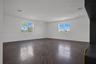 Interior space featuring dark wood-finish flooring, multi-pane windows, recessed lighting, and crown molding
