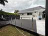 Expansive outdoor deck featuring dark wood-finish planking and stainless steel railings