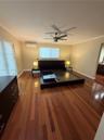 Rich wood-finish flooring with a neutral wall palette