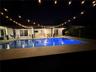 Rectangular swimming pool with light-colored coping