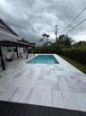 Rectangular swimming pool with white tile surround
