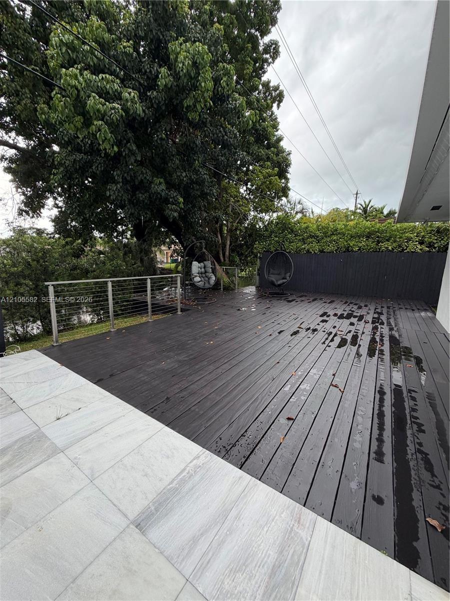 Expansive outdoor deck with dark wood-finish planking