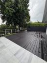 Expansive outdoor deck with dark wood-finish planking