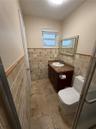 Warm-toned tiled flooring complemented by mosaic wall tiling