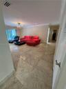 Polished tile flooring, recessed ceiling lighting, a chandelier fixture, and crown molding