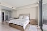 Neutral-toned interior featuring wood-finish flooring, full-height glass partitions, a glass-enclosed shower, and expansive sliding glass doors