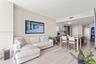Open-concept living space featuring wood-finish flooring, recessed lighting, and a kitchen equipped with a central island and contemporary cabinetry
