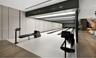 Private three-lane bowling alley featuring recessed linear lighting, integrated electronic scoring consoles, wood-finish flooring, and minimalist pane