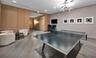Interior space featuring wood-paneled walls, wood-finish flooring, recessed lighting, and a modern geometric ceiling fixture