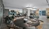 Open-concept interior featuring wood-finish flooring, recessed lighting, expansive floor-to-ceiling windows, and large circular pendant light fixtures