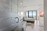 Floor-to-ceiling windows, stone-clad soaking tub, glass-enclosed shower with frosted detailing, wood-finish flooring, and recessed lighting