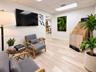 Wood-finish flooring and a suspended tile ceiling featuring recessed lighting
