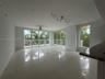 Open-concept interior featuring large-format tile flooring, expansive floor-to-ceiling glass sliding doors, integrated track lighting, a ceiling fan, 