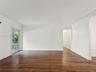 Interior space featuring wood-finish flooring, crown molding, and a full-light glass door