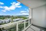 Private balcony featuring solid wall construction and white-frame glass railings