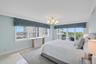 The serene primary suite offers balcony access and beautiful water views, creating a peaceful retreat above Delray Beach