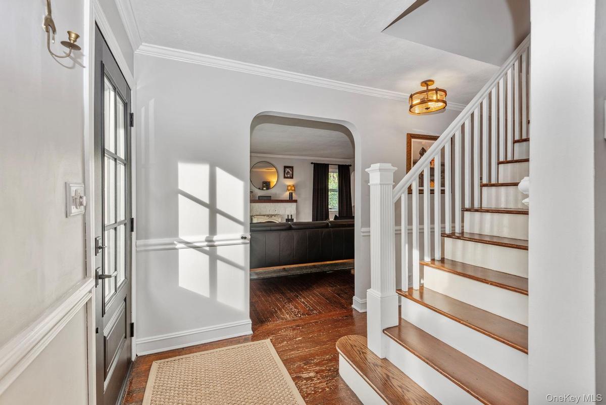Classic staircase and arches frame the entrance foyer.