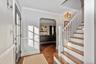 Classic staircase and arches frame the entrance foyer.