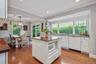 Bright and sunny classic kitchen with large windows looking out to the gardens.
