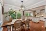 Dining room with arched entrance to kitchen and sliders to the deck and gardens.