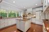 Beautiful kitchen with island and newer refrigerator.