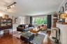 Cozy living room with wood burning stove and built-in bookshelves.