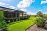 Fenced-in backyard with tropical landscape