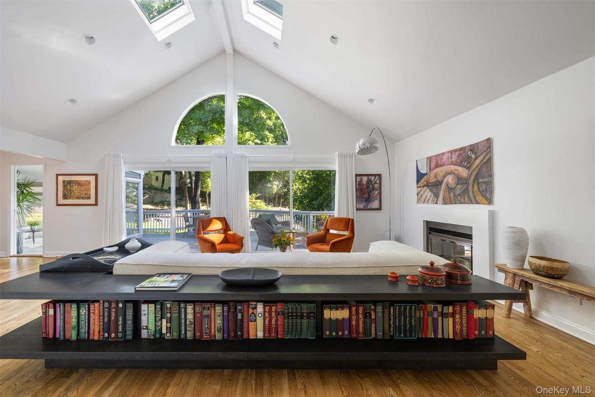 Sklights brighten the living spaces and large windows frame wooded views.