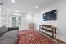 Lower level bedroom/tv room with doors to the yard.