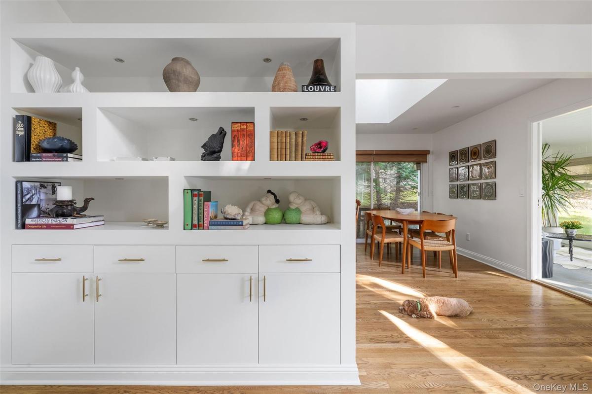 Living room is accented with custom cabinetry and gleaming oak floors.