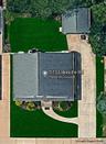 Aerial view featuring a detached garage, and a concrete driveway