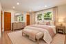 Virtually Staged Main Floor Bedroom - could serve as a primary bedroom door to full bathroom
